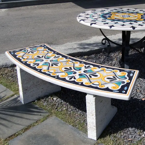 Bench with hand-decorated lava stone seat and white stone side walls.