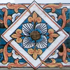 Decorated tile with a central blue flower inside a white diamond, ochre leaves and pink scrolls on dark blue