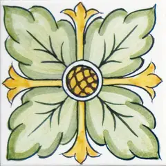 Carreau décoré avec quatre grandes feuilles vertes autour d'un centre jaune quadrillé et des pointes jaunes sur fond blanc