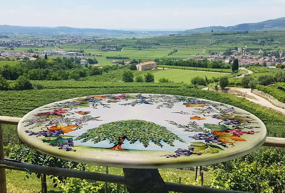 Artesole Olmo decorated lava stone table overlooking the landscape Artesole Olmo decorated lava stone table overlooking the landscape