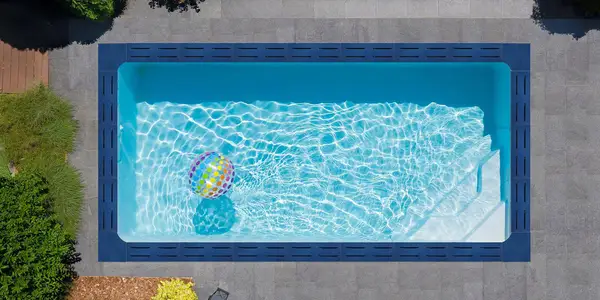 Aerial view of a swimming pool with lava stone surround