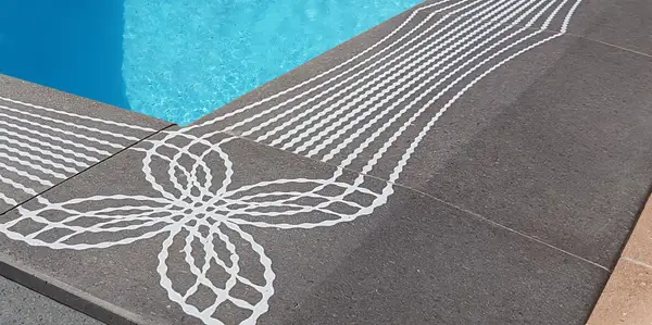 Lava stone pool edge with decorative screen print