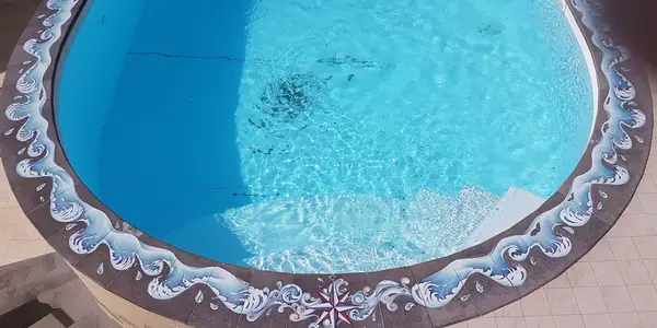 Swimming pool with decorated lava stone surround