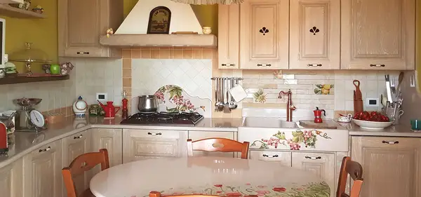 Messina faux masonry kitchen with wooden cabinet doors and a decorated sink in a corner layout