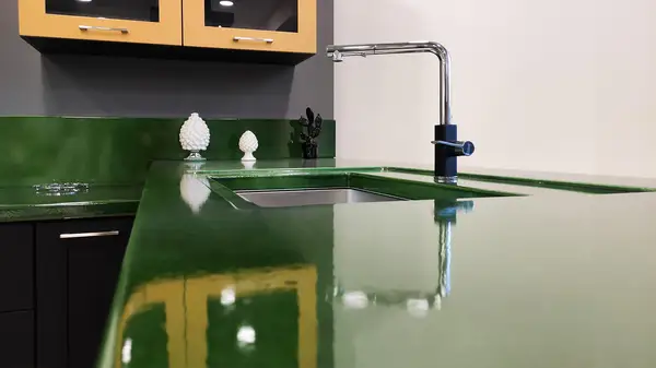 Corolla kitchen: glossy green countertop surface beside the sink Corolla kitchen: glossy green lava stone countertop surface beside the sink