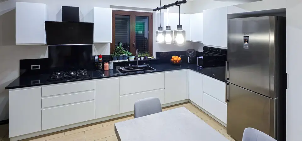 Trento modern modular kitchen with white cabinet doors and a black ceramicized lava stone countertop