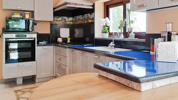 Pisa modern modular kitchen: corner layout with a blue ceramicized lava stone peninsula