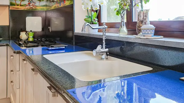 Pisa kitchen: blue lava stone countertop and inset sink in the corner layout