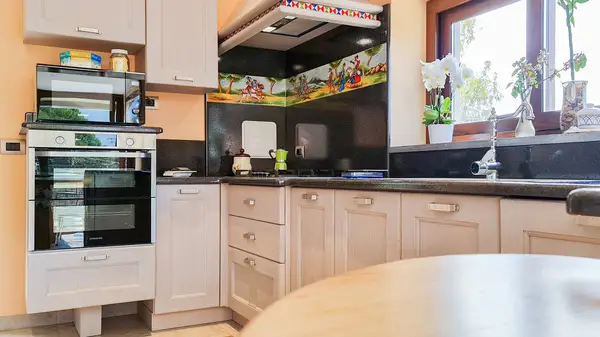 Pisa modern modular kitchen: raised oven and cooking area beside the window