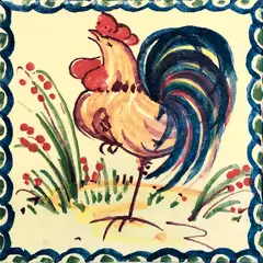 Decorated tile with a yellow rooster with a red comb and blue tail, small flowering stems and a blue border on a cream background