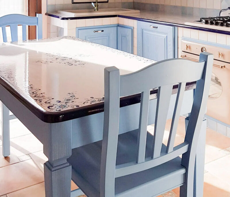 Light blue solid wood table with hand-decorated lava stone top