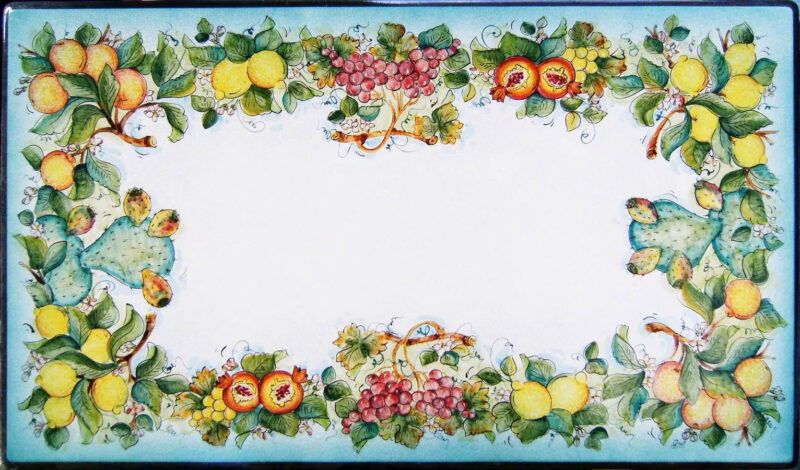 Rectangular lava stone table decorated by hand with lemons, pomegranates, red and yellow grapes, oranges and prickly pears