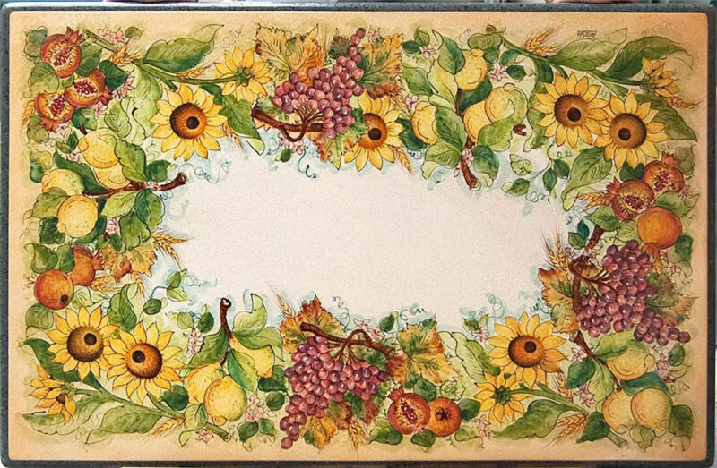 Lava stone table with sunflowers, pomegranates and lemons. Hand decorated in Caltagirone style