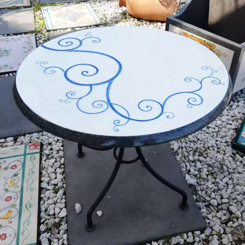 modern garden table in hand-decorated lava stone and iron base