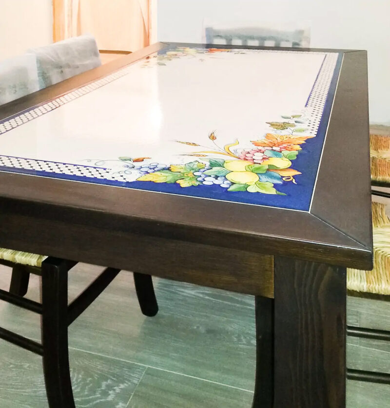 Solid wood table with hand-decorated recessed lava stone insert