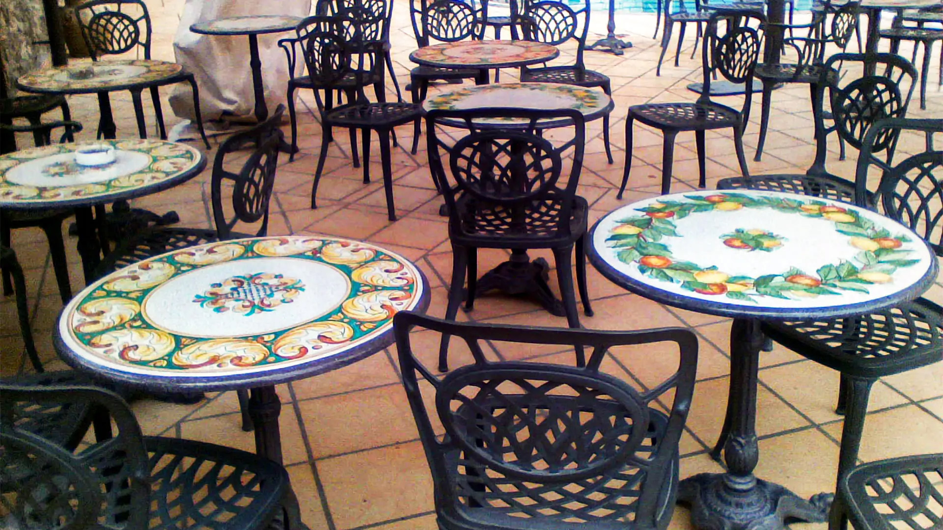 Tables for bars and pubs made of hand-decorated lava stone, iron bases and chairs